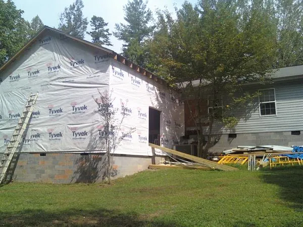 Tyvek wrapped gable on a new room addition beside an existing home in Pennsboro